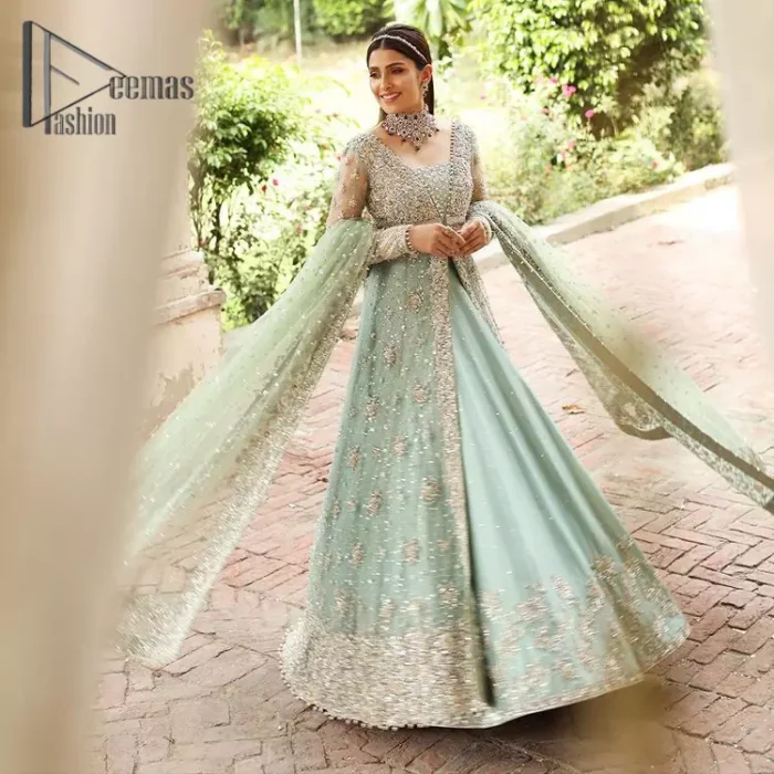 Stressed about your outfit on Walima?  Deemas Fashion will save your day. Make your moments more memorable with our ice blue front open maxi that is adorned with silver tilla, kora, and crystal work to enhance the beauty of maxi. In addition to this, the beauty of the square neckline of the stunning maxi speaks itself on your day. It is synchronized with the lehenga that's the border is as pretty as look in the picture. Finish this look with a dupatta that personifies the delicate embroidery on four sides and sequins detailing all over just to save your memorable day and give you a fairy look.