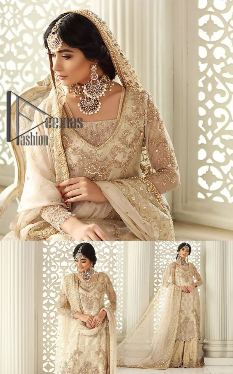 Pure bliss is seeing a bride smiling ear to ear through her whole wedding. Just go with a retro vibe on your Nikkah, everyone calls you super queen. This ivory long shirt is pleasingly furnished with golden and antique embroidery that includes kora, dabka, tilla, and crystal work. The inner blouse is intensified with a square neckline just to give you a super surprising look. It is systemized with ivory sharara that border is embellished with beautiful embroidery as well. Complete this amazing look with a dupatta which is adorned with a four-sided handsome border and sequins spray all over with so much love.
