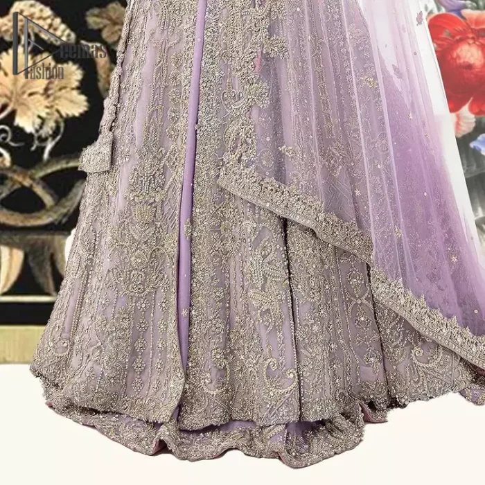 Creating the energy of modish is never been easy for a bride. So, Deemas Fashion presents the lilac front open maxi that is embellished with silver tilla, kora, and crystal soulful embroidery that all brides need for fashion. In addition to this, the V shape neckline of this maxi is looking so slayer when comes with full sleeves. Style with lilac can can lehenga that provides a glamorous look to any bride. Complete this look with a soft lilac dupatta that has a four-sided embellished border and sequins spray all over. This modish dress can be worn on your walima where you want to flaunt your style and steal everyone's heart.