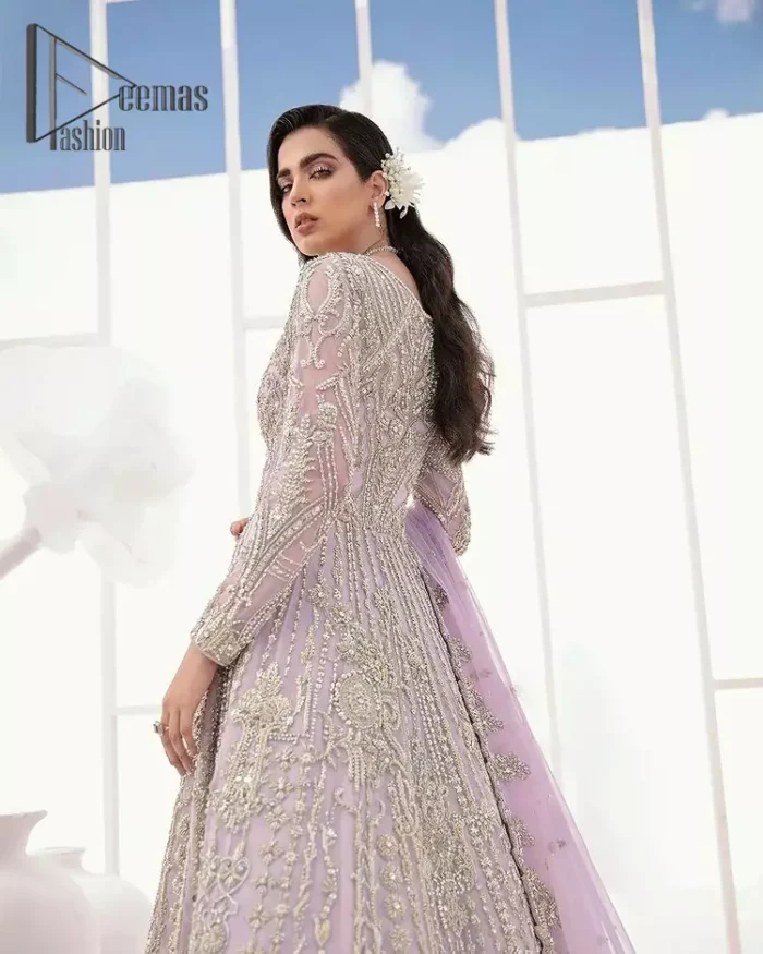 Creating the energy of modish is never been easy for a bride. So, Deemas Fashion presents the lilac front open maxi that is embellished with silver tilla, kora, and crystal soulful embroidery that all brides need for fashion. In addition to this, the V shape neckline of this maxi is looking so slayer when comes with full sleeves. Style with lilac can can lehenga that provides a glamorous look to any bride. Complete this look with a soft lilac dupatta that has a four-sided embellished border and sequins spray all over. This modish dress can be worn on your walima where you want to flaunt your style and steal everyone's heart.