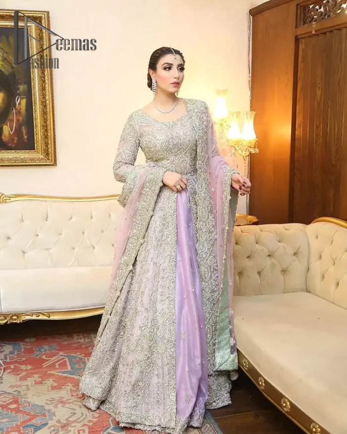 Creating the energy of modish is never been easy for a bride. So, Deemas Fashion presents the lilac front open maxi that is embellished with silver tilla, kora, and crystal soulful embroidery that all brides need for fashion. In addition to this, the V shape neckline of this maxi is looking so slayer when comes with full sleeves. Style with lilac can can lehenga that provides a glamorous look to any bride. Complete this look with a soft lilac dupatta that has a four-sided embellished border and sequins spray all over. This modish dress can be worn on your walima where you want to flaunt your style and steal everyone's heart.