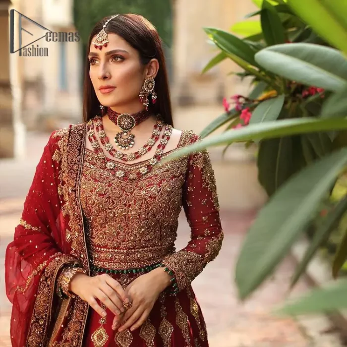 We're sure that all girls love slipping into "maroon outfits for weddings" So, we create this maroon article that will capture your moments on your big day. All details of the blouse are just amazing as it is adorned with golden tilla, kora, dabka embroidery. Just look closely at the boat shape neckline of the blouse that gives super-duper look when combine with full-length sleeves. Furthermore, it is coordinated with can can lehenga just to boost up your day by giving dreamy look. Conclude this maroon article with a chiffon dupatta that has four-sided embellished lace to capture your moments.