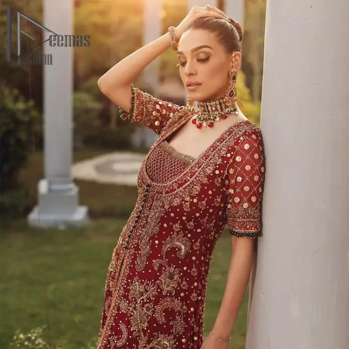 Just fulfil your love for maroon on your Big day with DeemasFashion. Giving you all the glam with this maroon scalloped front open frock which is beautifully sprinkled with antique tilla, dabka, kora, crystal, and Resham thread work. In addition to this, the square neckline and half sleeves with multicolor embroidery look so stunning and soothing on your Big day. It is attractively synchronized with cigarette pants to grant you a remarkable aesthetic focusing look.