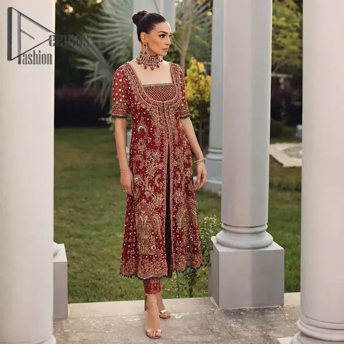 Just fulfil your love for maroon on your Big day with DeemasFashion. Giving you all the glam with this maroon scalloped front open frock which is beautifully sprinkled with antique tilla, dabka, kora, crystal, and Resham thread work. In addition to this, the square neckline and half sleeves with multicolor embroidery look so stunning and soothing on your Big day. It is attractively synchronized with cigarette pants to grant you a remarkable aesthetic focusing look.