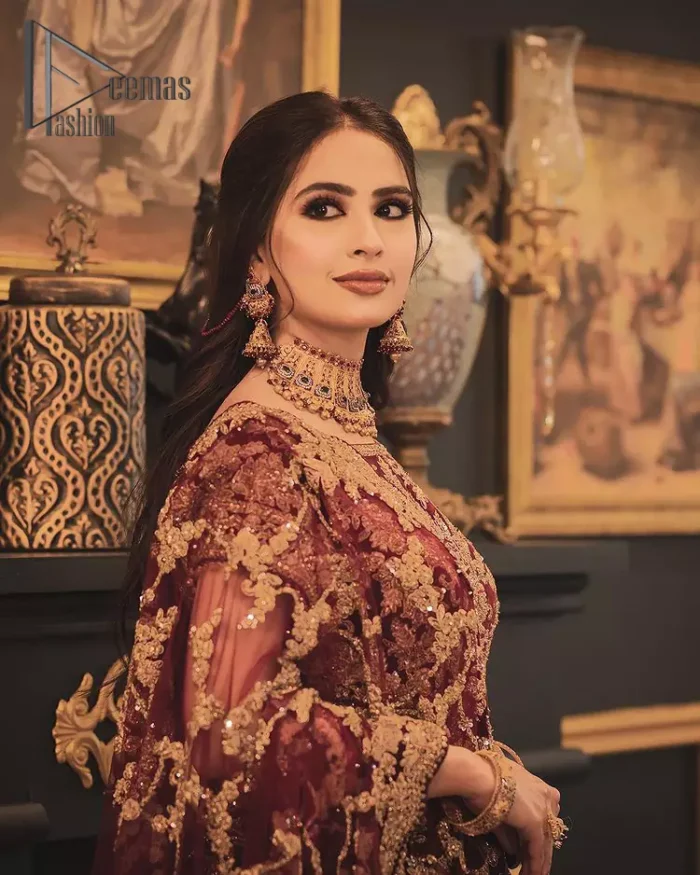 With the right outfit, every bride can rule the world! As nothing makes a bride more beautiful than the trust of her outfit. Introducing maroon half sleeves blouse that is fully embellished with tilla, kora and dabka work. In addition to this, the boat shape neckline of this blouse that is made with pure velvet gives you a dreamy look. It is synchronized with a velvet lehenga that is adorned with priceless heavy embroidery. Finish this look with an organza dupatta, embellished with embroidered scalloped borders to give you a relaxing and soothing look on your reception.