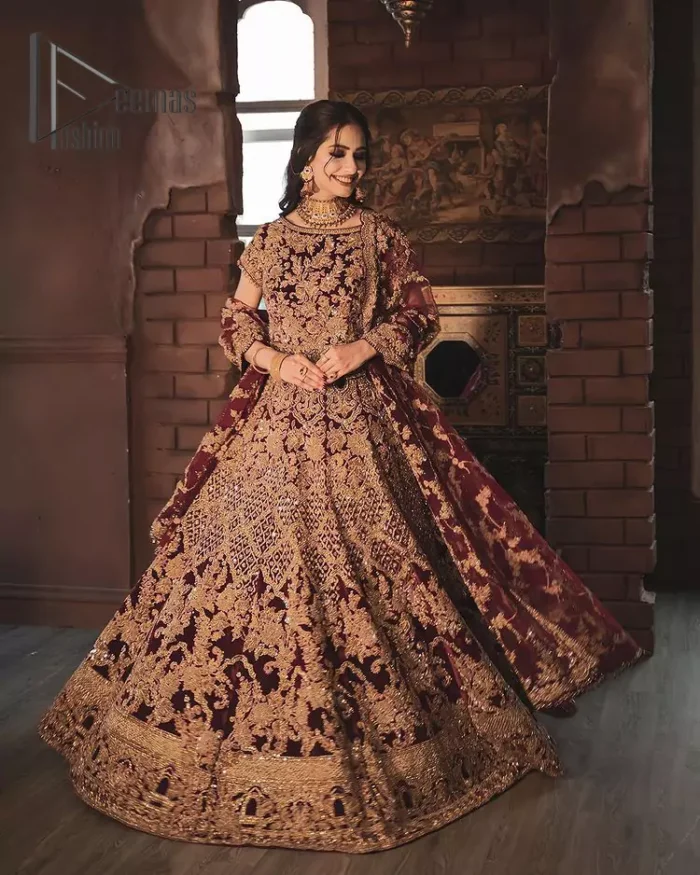 With the right outfit, every bride can rule the world! As nothing makes a bride more beautiful than the trust of her outfit. Introducing maroon half sleeves blouse that is fully embellished with tilla, kora and dabka work. In addition to this, the boat shape neckline of this blouse that is made with pure velvet gives you a dreamy look. It is synchronized with a velvet lehenga that is adorned with priceless heavy embroidery. Finish this look with an organza dupatta, embellished with embroidered scalloped borders to give you a relaxing and soothing look on your reception.