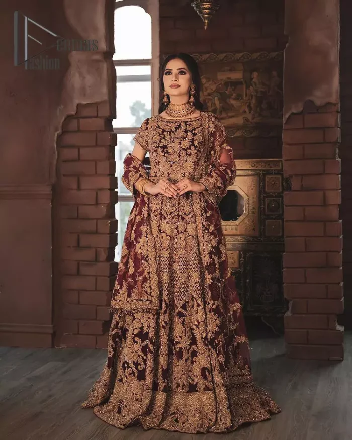 With the right outfit, every bride can rule the world! As nothing makes a bride more beautiful than the trust of her outfit. Introducing maroon half sleeves blouse that is fully embellished with tilla, kora and dabka work. In addition to this, the boat shape neckline of this blouse that is made with pure velvet gives you a dreamy look. It is synchronized with a velvet lehenga that is adorned with priceless heavy embroidery. Finish this look with an organza dupatta, embellished with embroidered scalloped borders to give you a relaxing and soothing look on your reception.