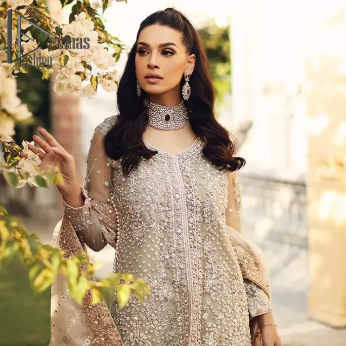 It's time to stock up your eventry wardrobe with the ensembles that have everyone hooked. Your mini fashionistas got stunned in this mint green and rust attire. Just look at the super detailing of a mint green front open shirt that is ornamented with silver embroidery that includes tilla, kora dabka, and crystal work. It is further enhanced with a Round neckline that gives so soothing display. It is coordinated with a Rust sharara, the border is sprinkled with silver embroidery and sequins spray all over that looks just priceless at any party. End up this attire with an ivory dupatta with a four-sided embellished border.