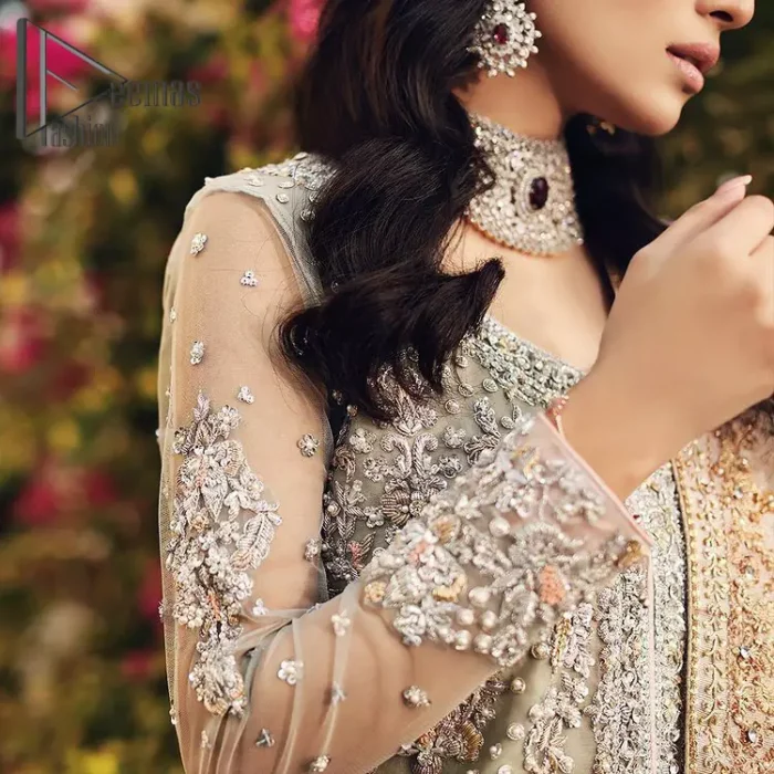 It's time to stock up your eventry wardrobe with the ensembles that have everyone hooked. Your mini fashionistas got stunned in this mint green and rust attire. Just look at the super detailing of a mint green front open shirt that is ornamented with silver embroidery that includes tilla, kora dabka, and crystal work. It is further enhanced with a Round neckline that gives so soothing display. It is coordinated with a Rust sharara, the border is sprinkled with silver embroidery and sequins spray all over that looks just priceless at any party. End up this attire with an ivory dupatta with a four-sided embellished border.