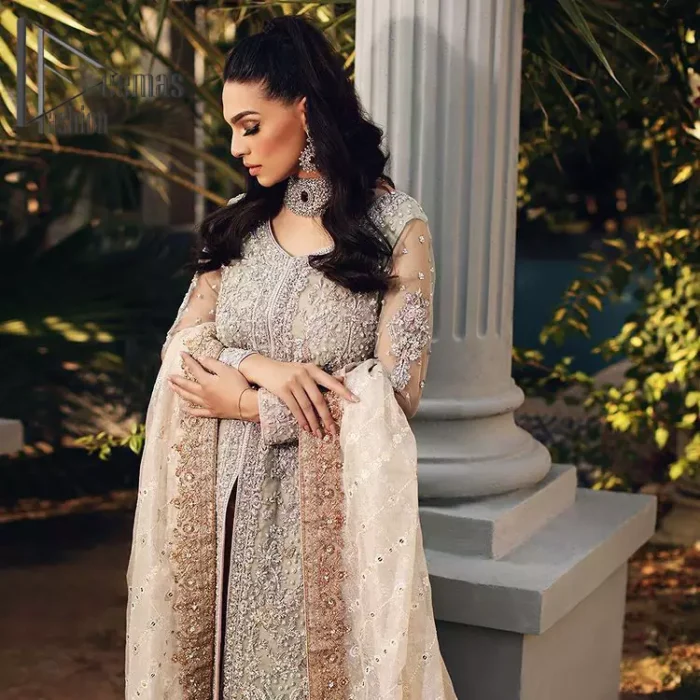 It's time to stock up your eventry wardrobe with the ensembles that have everyone hooked. Your mini fashionistas got stunned in this mint green and rust attire. Just look at the super detailing of a mint green front open shirt that is ornamented with silver embroidery that includes tilla, kora dabka, and crystal work. It is further enhanced with a Round neckline that gives so soothing display. It is coordinated with a Rust sharara, the border is sprinkled with silver embroidery and sequins spray all over that looks just priceless at any party. End up this attire with an ivory dupatta with a four-sided embellished border.