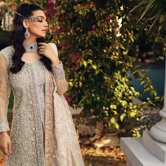 It's time to stock up your eventry wardrobe with the ensembles that have everyone hooked. Your mini fashionistas got stunned in this mint green and rust attire. Just look at the super detailing of a mint green front open shirt that is ornamented with silver embroidery that includes tilla, kora dabka, and crystal work. It is further enhanced with a Round neckline that gives so soothing display. It is coordinated with a Rust sharara, the border is sprinkled with silver embroidery and sequins spray all over that looks just priceless at any party. End up this attire with an ivory dupatta with a four-sided embellished border.