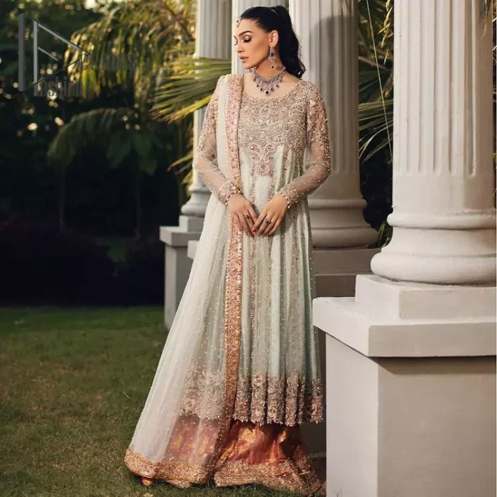 Unveiling your inner happiness is what it's all about your outfit. Just seep royalty in the texture and layers of this mint green scalloped maxi of DeemasFashion. The round neckline of the maxi is looking super aesthetic when comes with full sleeves. Further, the maxi is beautifully adorned with golden and antique embroidery that includes mainly tilla, gota, and crystal work just to give you a soothing and amazing look. Marvellously maxi is paired up with rust sharara with embroidered border to express your happiness as well. Finish this look with a mint green dupatta that is highlighted with a rust border and sequins spray all over it that seeps the royalty of the article.