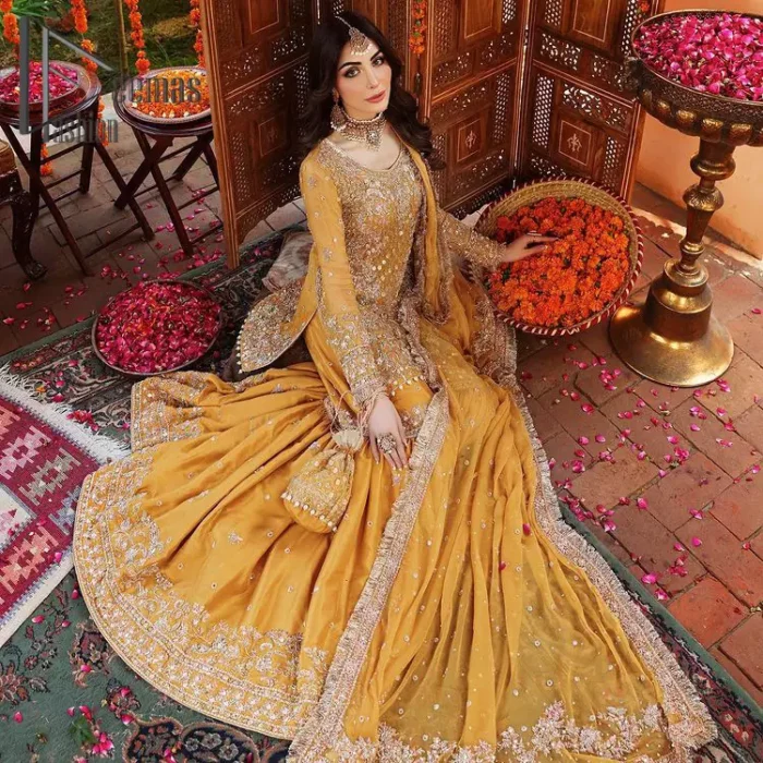 The shirt is the mirror of the mind and the dupatta confesses secrets of the heart. This mustard soft-toned article is highlighted with fascinating golden and antique kora, dabka, and crystal work. The shirt is further enhanced your mayon look with a traditional round neckline and full sleeves. It is paired up with gharara that is prettified with priceless border embroidery. Finish this look with the same colour dupatta that have four-sided embellished lace and Kiran. Further the sequins spray on the dupatta increases the beauty of the article which is every bride's dream.