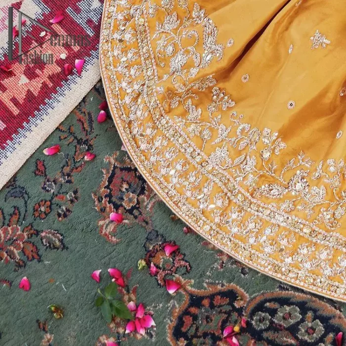 The shirt is the mirror of the mind and the dupatta confesses secrets of the heart. This mustard soft-toned article is highlighted with fascinating golden and antique kora, dabka, and crystal work. The shirt is further enhanced your mayon look with a traditional round neckline and full sleeves. It is paired up with gharara that is prettified with priceless border embroidery. Finish this look with the same colour dupatta that have four-sided embellished lace and Kiran. Further the sequins spray on the dupatta increases the beauty of the article which is every bride's dream.