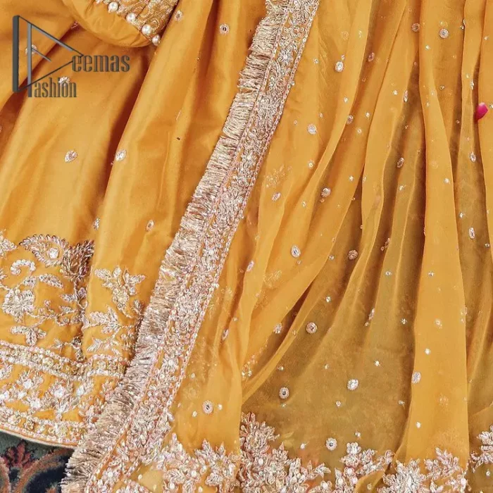 The shirt is the mirror of the mind and the dupatta confesses secrets of the heart. This mustard soft-toned article is highlighted with fascinating golden and antique kora, dabka, and crystal work. The shirt is further enhanced your mayon look with a traditional round neckline and full sleeves. It is paired up with gharara that is prettified with priceless border embroidery. Finish this look with the same colour dupatta that have four-sided embellished lace and Kiran. Further the sequins spray on the dupatta increases the beauty of the article which is every bride's dream.