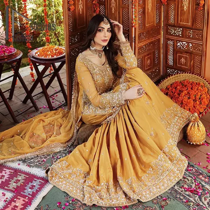 The shirt is the mirror of the mind and the dupatta confesses secrets of the heart. This mustard soft-toned article is highlighted with fascinating golden and antique kora, dabka, and crystal work. The shirt is further enhanced your mayon look with a traditional round neckline and full sleeves. It is paired up with gharara that is prettified with priceless border embroidery. Finish this look with the same colour dupatta that have four-sided embellished lace and Kiran. Further the sequins spray on the dupatta increases the beauty of the article which is every bride's dream.