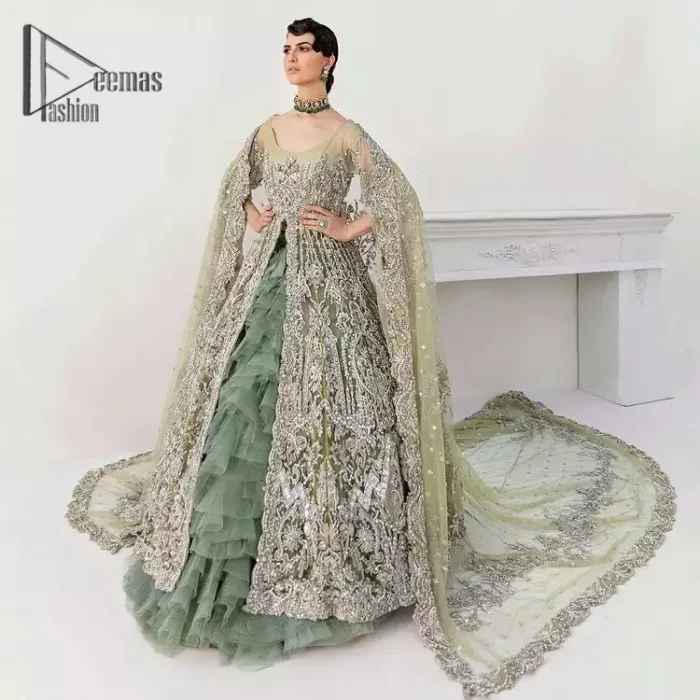 Confected on a luxury outfit with spectacular colors and contrast, this style serves for an elevated look. Delicate embroidery of maxi that involves kora, dabka, crystal work and front open style of maxi are infused together for the olive green affair. The very unbelievable sleeve style of the maxi looks super stunning and jazz up your event wardrobe. It is gracefully synchronized with a full frilled lehenga to enhance the beauty of the article. Complete this stunning look with an olive green scalloped dupatta that is embellished with four-sided borders and small motifs all around that reflect the mood of everyone.