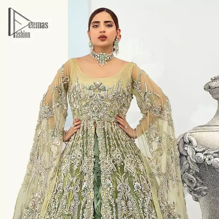 Confected on a luxury outfit with spectacular colors and contrast, this style serves for an elevated look. Delicate embroidery of maxi that involves kora, dabka, crystal work and front open style of maxi are infused together for the olive green affair. The very unbelievable sleeve style of the maxi looks super stunning and jazz up your event wardrobe. It is gracefully synchronized with a full frilled lehenga to enhance the beauty of the article. Complete this stunning look with an olive green scalloped dupatta that is embellished with four-sided borders and small motifs all around that reflect the mood of everyone.