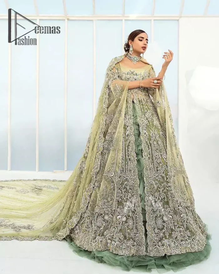 Confected on a luxury outfit with spectacular colors and contrast, this style serves for an elevated look. Delicate embroidery of maxi that involves kora, dabka, crystal work and front open style of maxi are infused together for the olive green affair. The very unbelievable sleeve style of the maxi looks super stunning and jazz up your event wardrobe. It is gracefully synchronized with a full frilled lehenga to enhance the beauty of the article. Complete this stunning look with an olive green scalloped dupatta that is embellished with four-sided borders and small motifs all around that reflect the mood of everyone.