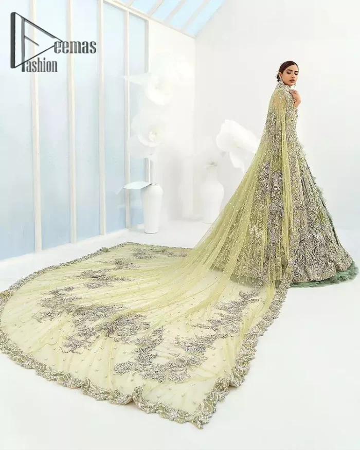 Confected on a luxury outfit with spectacular colors and contrast, this style serves for an elevated look. Delicate embroidery of maxi that involves kora, dabka, crystal work and front open style of maxi are infused together for the olive green affair. The very unbelievable sleeve style of the maxi looks super stunning and jazz up your event wardrobe. It is gracefully synchronized with a full frilled lehenga to enhance the beauty of the article. Complete this stunning look with an olive green scalloped dupatta that is embellished with four-sided borders and small motifs all around that reflect the mood of everyone.