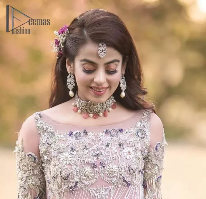 If you want to go high on the fashion charts then just go with this pink outfit of Deemas Fashion. This full sleeve pink pishwas is certainly any girl's dream that is fully embellished with multiple colour thread embroidery and silver zardozi work that includes kora, dabka, and crystal work to get so cool look. Furthermore, the boat shape neckline of this pishwas is just increasing the focus of this article. It is synchronized with the back train frilled lehenga to enhance your beauty on any occasion.