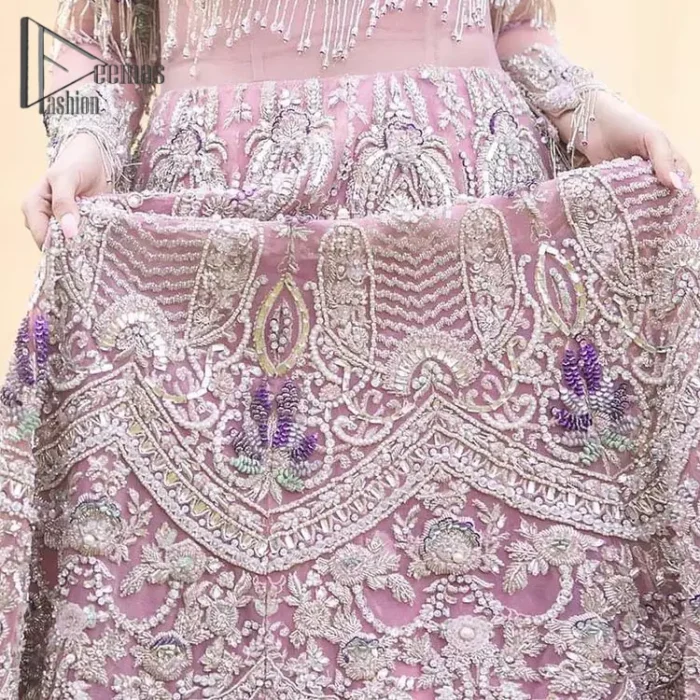 If you want to go high on the fashion charts then just go with this pink outfit of Deemas Fashion. This full sleeve pink pishwas is certainly any girl's dream that is fully embellished with multiple colour thread embroidery and silver zardozi work that includes kora, dabka, and crystal work to get so cool look. Furthermore, the boat shape neckline of this pishwas is just increasing the focus of this article. It is synchronized with the back train frilled lehenga to enhance your beauty on any occasion.