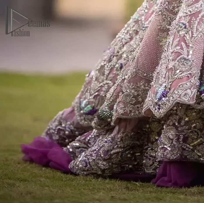 If you want to go high on the fashion charts then just go with this pink outfit of Deemas Fashion. This full sleeve pink pishwas is certainly any girl's dream that is fully embellished with multiple colour thread embroidery and silver zardozi work that includes kora, dabka, and crystal work to get so cool look. Furthermore, the boat shape neckline of this pishwas is just increasing the focus of this article. It is synchronized with the back train frilled lehenga to enhance your beauty on any occasion.