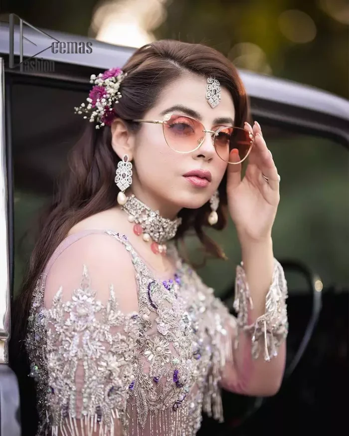 If you want to go high on the fashion charts then just go with this pink outfit of Deemas Fashion. This full sleeve pink pishwas is certainly any girl's dream that is fully embellished with multiple colour thread embroidery and silver zardozi work that includes kora, dabka, and crystal work to get so cool look. Furthermore, the boat shape neckline of this pishwas is just increasing the focus of this article. It is synchronized with the back train frilled lehenga to enhance your beauty on any occasion.