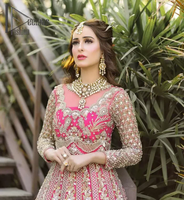 A colour splash, a floral dream. Let your energy shine with this pink outfit. Make a dramatic entry with pink scalloped pishwas that's full sleeves look super-duper amazing when combine with boat shape neckline. It is streaking with the finest silver and light golden embroidery that counts in tilla, kora, dabka, and crystal work to give you an enthusiast look. Further, this scalloped pishwas is coordinated with a Pink dupatta that is adorned with four-sided borders and sequins spray all over to give you shiny energy at any party.