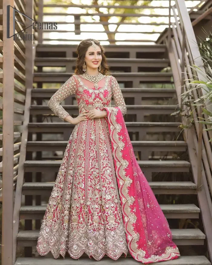 A colour splash, a floral dream. Let your energy shine with this pink outfit. Make a dramatic entry with pink scalloped pishwas that's full sleeves look super-duper amazing when combine with boat shape neckline. It is streaking with the finest silver and light golden embroidery that counts in tilla, kora, dabka, and crystal work to give you an enthusiast look. Further, this scalloped pishwas is coordinated with a Pink dupatta that is adorned with four-sided borders and sequins spray all over to give you shiny energy at any party.