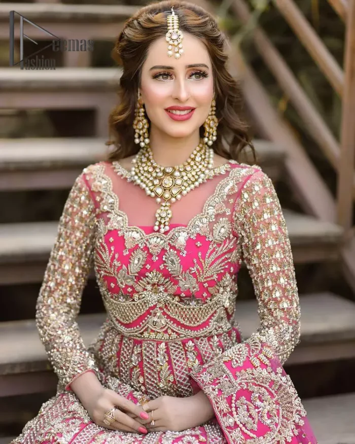 A colour splash, a floral dream. Let your energy shine with this pink outfit. Make a dramatic entry with pink scalloped pishwas that's full sleeves look super-duper amazing when combine with boat shape neckline. It is streaking with the finest silver and light golden embroidery that counts in tilla, kora, dabka, and crystal work to give you an enthusiast look. Further, this scalloped pishwas is coordinated with a Pink dupatta that is adorned with four-sided borders and sequins spray all over to give you shiny energy at any party.