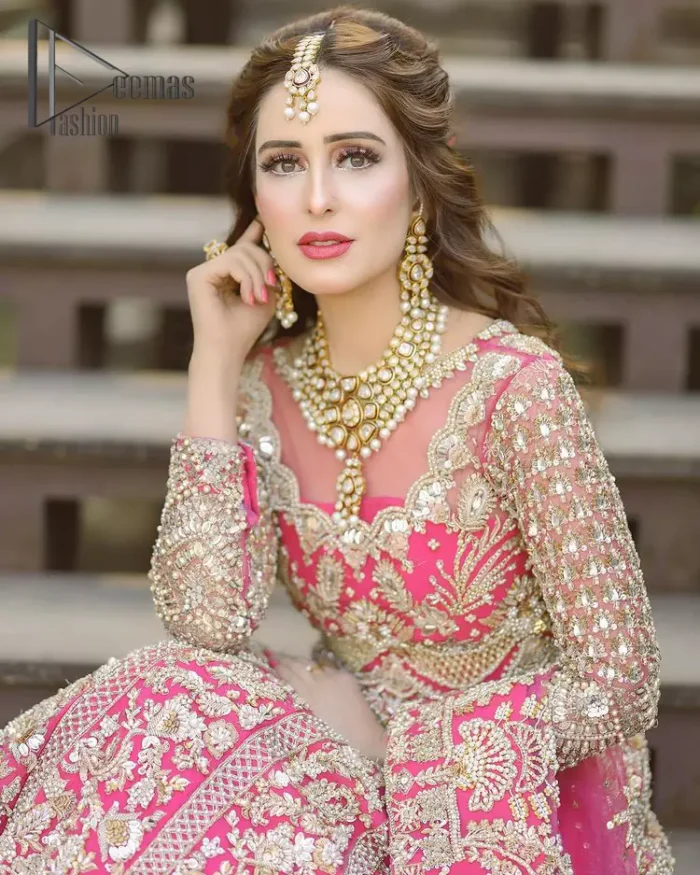 A colour splash, a floral dream. Let your energy shine with this pink outfit. Make a dramatic entry with pink scalloped pishwas that's full sleeves look super-duper amazing when combine with boat shape neckline. It is streaking with the finest silver and light golden embroidery that counts in tilla, kora, dabka, and crystal work to give you an enthusiast look. Further, this scalloped pishwas is coordinated with a Pink dupatta that is adorned with four-sided borders and sequins spray all over to give you shiny energy at any party.