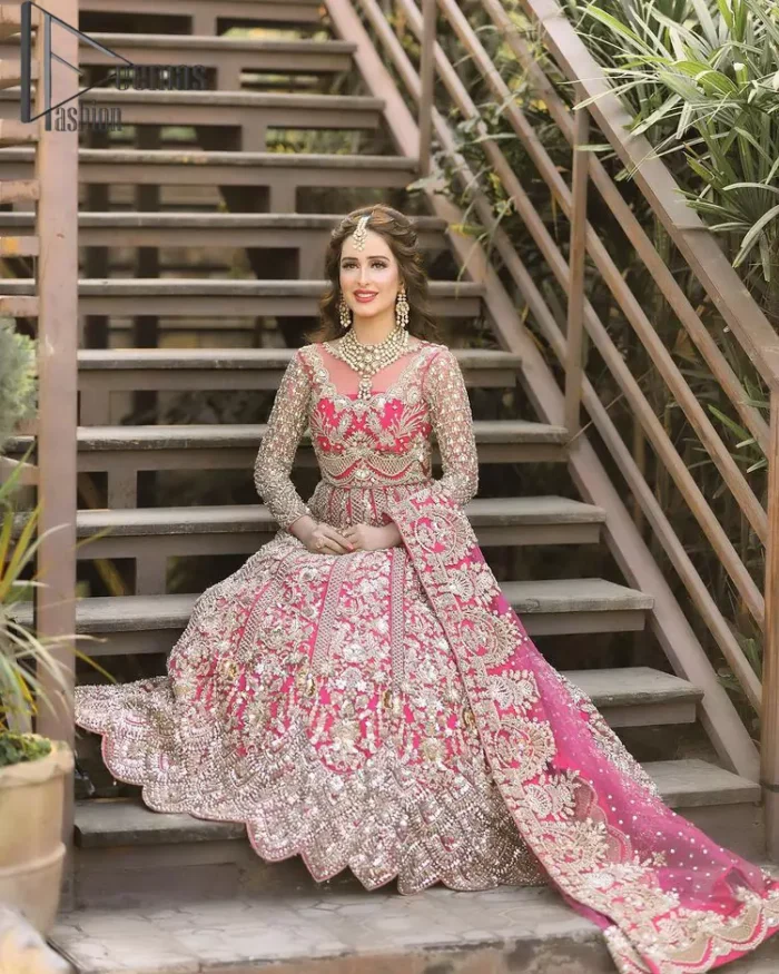 A colour splash, a floral dream. Let your energy shine with this pink outfit. Make a dramatic entry with pink scalloped pishwas that's full sleeves look super-duper amazing when combine with boat shape neckline. It is streaking with the finest silver and light golden embroidery that counts in tilla, kora, dabka, and crystal work to give you an enthusiast look. Further, this scalloped pishwas is coordinated with a Pink dupatta that is adorned with four-sided borders and sequins spray all over to give you shiny energy at any party.