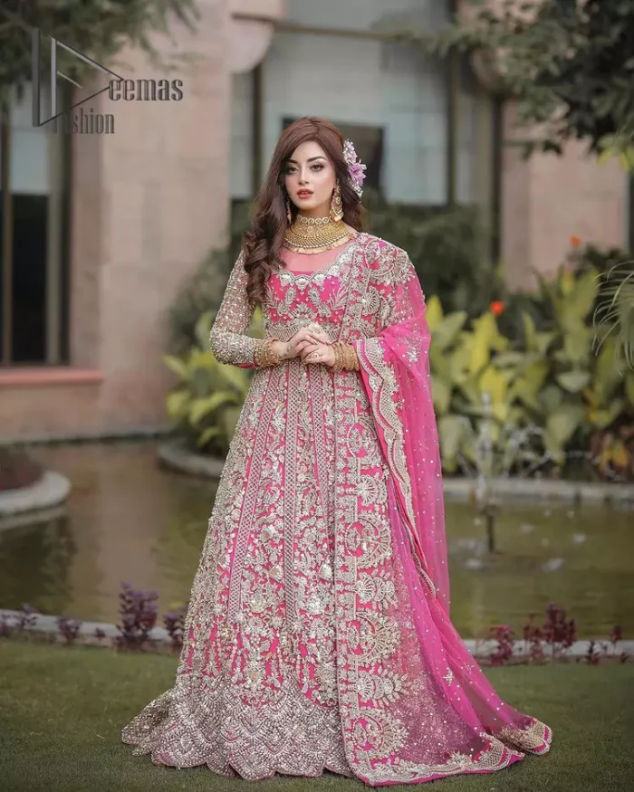 A colour splash, a floral dream. Let your energy shine with this pink outfit. Make a dramatic entry with pink scalloped pishwas that's full sleeves look super-duper amazing when combine with boat shape neckline. It is streaking with the finest silver and light golden embroidery that counts in tilla, kora, dabka, and crystal work to give you an enthusiast look. Further, this scalloped pishwas is coordinated with a Pink dupatta that is adorned with four-sided borders and sequins spray all over to give you shiny energy at any party.