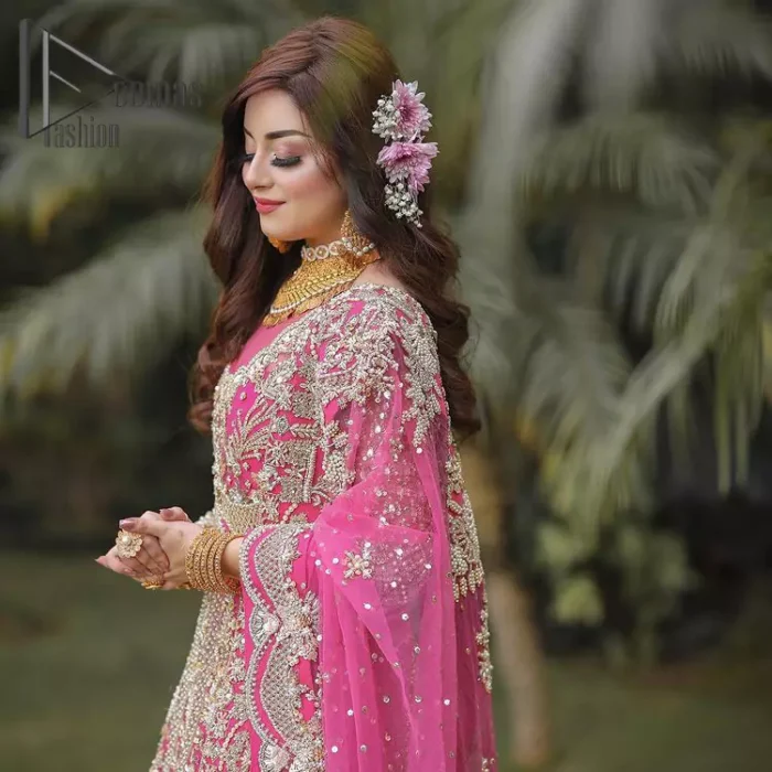 A colour splash, a floral dream. Let your energy shine with this pink outfit. Make a dramatic entry with pink scalloped pishwas that's full sleeves look super-duper amazing when combine with boat shape neckline. It is streaking with the finest silver and light golden embroidery that counts in tilla, kora, dabka, and crystal work to give you an enthusiast look. Further, this scalloped pishwas is coordinated with a Pink dupatta that is adorned with four-sided borders and sequins spray all over to give you shiny energy at any party.