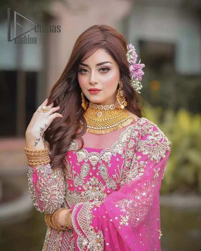 A colour splash, a floral dream. Let your energy shine with this pink outfit. Make a dramatic entry with pink scalloped pishwas that's full sleeves look super-duper amazing when combine with boat shape neckline. It is streaking with the finest silver and light golden embroidery that counts in tilla, kora, dabka, and crystal work to give you an enthusiast look. Further, this scalloped pishwas is coordinated with a Pink dupatta that is adorned with four-sided borders and sequins spray all over to give you shiny energy at any party.