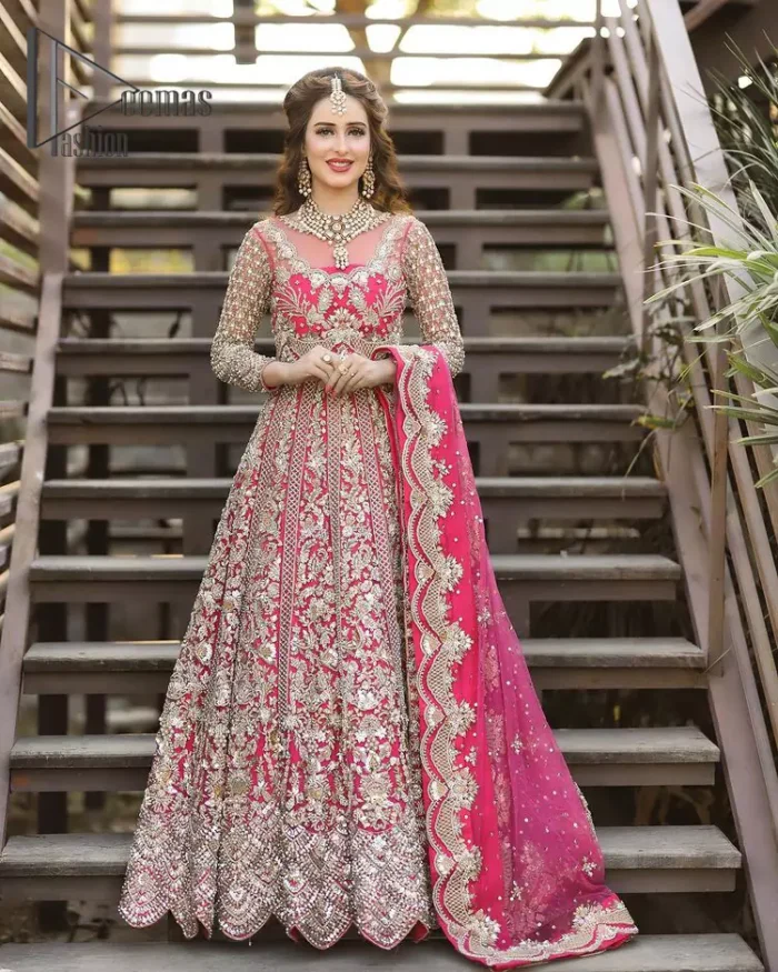 A colour splash, a floral dream. Let your energy shine with this pink outfit. Make a dramatic entry with pink scalloped pishwas that's full sleeves look super-duper amazing when combine with boat shape neckline. It is streaking with the finest silver and light golden embroidery that counts in tilla, kora, dabka, and crystal work to give you an enthusiast look. Further, this scalloped pishwas is coordinated with a Pink dupatta that is adorned with four-sided borders and sequins spray all over to give you shiny energy at any party.