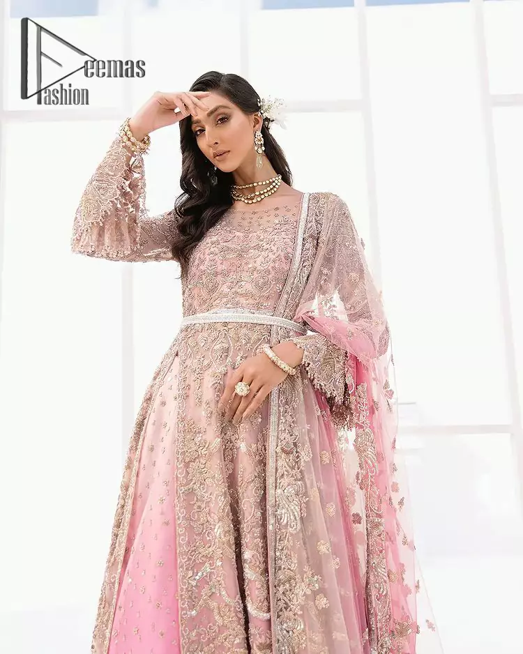 There is nothing more magical than wearing pink colour on your Walima. Our pink side slit open maxi is handsomely embellished with the magic of silver embroidery that involves kora, antiques, dabka, sequins, and pearls just to give you a dream fairy look. Further, the back train of the maxi is granted you the super dazzling effect. It is beautifully organized with a pink dupatta that is embellished with four-sided borders. Further, the dupatta is highlighted with the spray of tiny floral motifs all over just to enhance the fairy look.