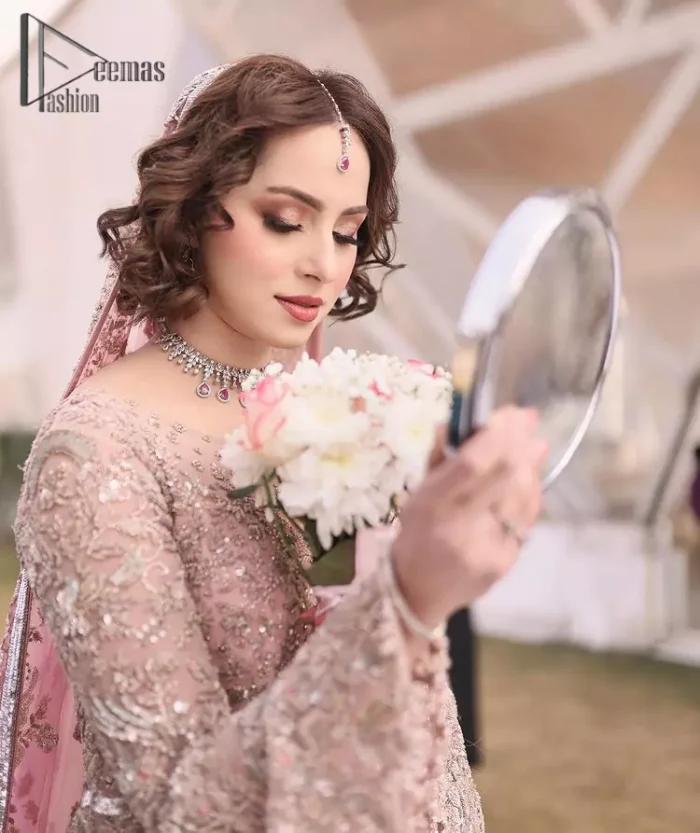 There is nothing more magical than wearing pink colour on your Walima. Our pink side slit open maxi is handsomely embellished with the magic of silver embroidery that involves kora, antiques, dabka, sequins, and pearls just to give you a dream fairy look. Further, the back train of the maxi is granted you the super dazzling effect. It is beautifully organized with a pink dupatta that is embellished with four-sided borders. Further, the dupatta is highlighted with the spray of tiny floral motifs all over just to enhance the fairy look.