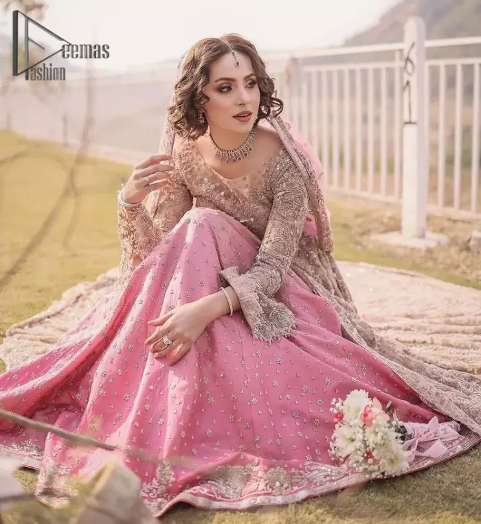 There is nothing more magical than wearing pink colour on your Walima. Our pink side slit open maxi is handsomely embellished with the magic of silver embroidery that involves kora, antiques, dabka, sequins, and pearls just to give you a dream fairy look. Further, the back train of the maxi is granted you the super dazzling effect. It is beautifully organized with a pink dupatta that is embellished with four-sided borders. Further, the dupatta is highlighted with the spray of tiny floral motifs all over just to enhance the fairy look.