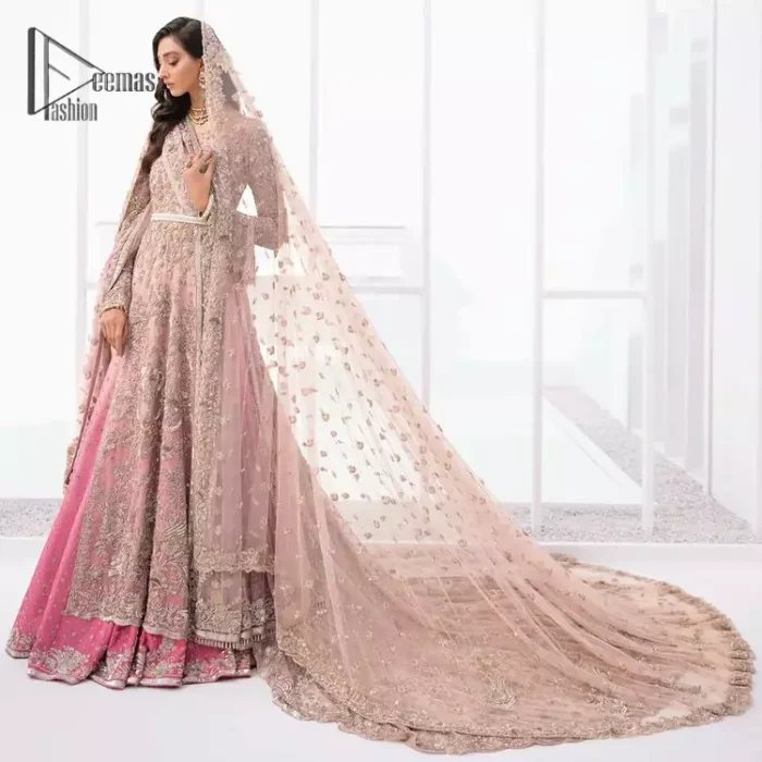 There is nothing more magical than wearing pink colour on your Walima. Our pink side slit open maxi is handsomely embellished with the magic of silver embroidery that involves kora, antiques, dabka, sequins, and pearls just to give you a dream fairy look. Further, the back train of the maxi is granted you the super dazzling effect. It is beautifully organized with a pink dupatta that is embellished with four-sided borders. Further, the dupatta is highlighted with the spray of tiny floral motifs all over just to enhance the fairy look.