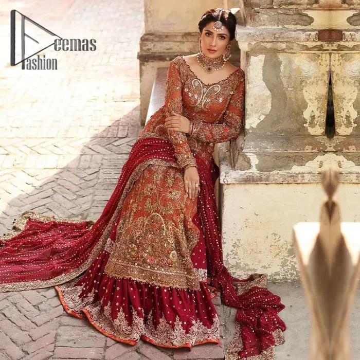 Wondering what an aesthetic bridal attire looks like? The beauty in red makes you go gaga over your look and you cannot stop snowing over you. Wearing the rust long shirt on your big day that is marvellously adorned with kora, dabka, and sequins work. Furthermore, the round neckline is also beautifully decorated to enhance the beauty of the outfit. It is synchronized with a red lehenga that has sequins sprayed all over to give you a crazy look as well. Finish this look with a red dupatta that has four-sided embellished borders as well.