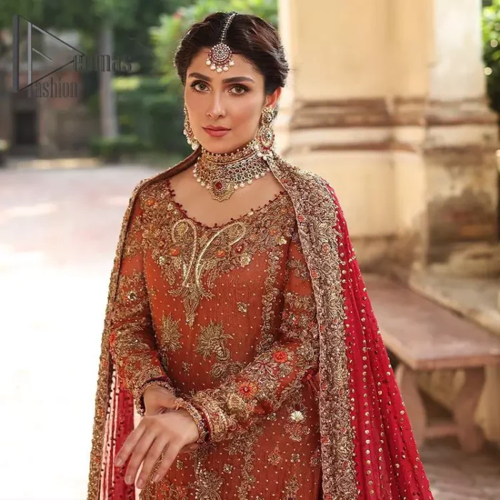 Wondering what an aesthetic bridal attire looks like? The beauty in red makes you go gaga over your look and you cannot stop snowing over you. Wearing the rust long shirt on your big day that is marvellously adorned with kora, dabka, and sequins work. Furthermore, the round neckline is also beautifully decorated to enhance the beauty of the outfit. It is synchronized with a red lehenga that has sequins sprayed all over to give you a crazy look as well. Finish this look with a red dupatta that has four-sided embellished borders as well.
