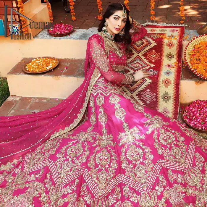 A color splash is always a floral dream. Let your energy shine with these popping Shocking Pink blouse that is ornamented with golden embroidery that involves tilla, dabka, Resham, and multi-color thread work just to magnify the display of the outfit. In addition to this, the full sleeves of the blouse when combined with a square neckline it gives a dazzling effect to the article. It is beautifully organized with can can lehenga that is also embellished with golden embroidery as well. Finalize this article with the same color dupatta that is adorned with four-sided lace and sequins spray all over just to fulfill your floral dream on your walima day.