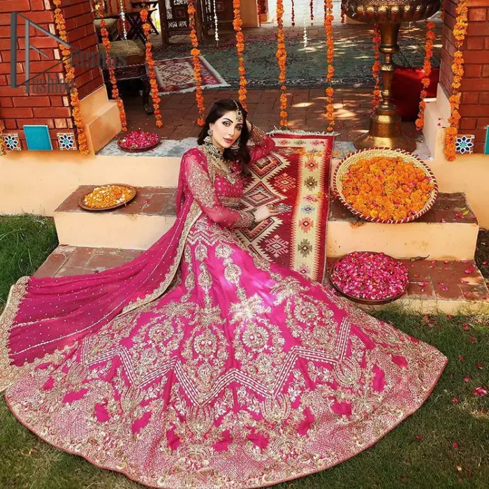 A color splash is always a floral dream. Let your energy shine with these popping Shocking Pink blouse that is ornamented with golden embroidery that involves tilla, dabka, Resham, and multi-color thread work just to magnify the display of the outfit. In addition to this, the full sleeves of the blouse when combined with a square neckline it gives a dazzling effect to the article. It is beautifully organized with can can lehenga that is also embellished with golden embroidery as well. Finalize this article with the same color dupatta that is adorned with four-sided lace and sequins spray all over just to fulfill your floral dream on your walima day.