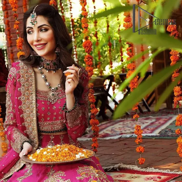 A color splash is always a floral dream. Let your energy shine with these popping Shocking Pink blouse that is ornamented with golden embroidery that involves tilla, dabka, Resham, and multi-color thread work just to magnify the display of the outfit. In addition to this, the full sleeves of the blouse when combined with a square neckline it gives a dazzling effect to the article. It is beautifully organized with can can lehenga that is also embellished with golden embroidery as well. Finalize this article with the same color dupatta that is adorned with four-sided lace and sequins spray all over just to fulfill your floral dream on your walima day.