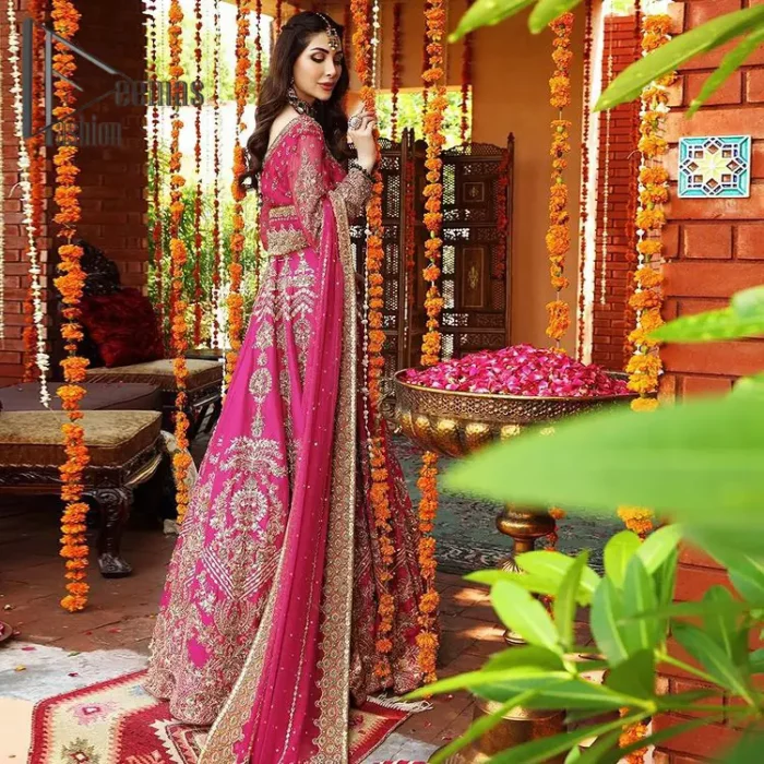 A color splash is always a floral dream. Let your energy shine with these popping Shocking Pink blouse that is ornamented with golden embroidery that involves tilla, dabka, Resham, and multi-color thread work just to magnify the display of the outfit. In addition to this, the full sleeves of the blouse when combined with a square neckline it gives a dazzling effect to the article. It is beautifully organized with can can lehenga that is also embellished with golden embroidery as well. Finalize this article with the same color dupatta that is adorned with four-sided lace and sequins spray all over just to fulfill your floral dream on your walima day.