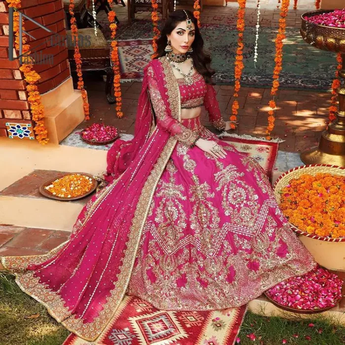 A color splash is always a floral dream. Let your energy shine with these popping Shocking Pink blouse that is ornamented with golden embroidery that involves tilla, dabka, Resham, and multi-color thread work just to magnify the display of the outfit. In addition to this, the full sleeves of the blouse when combined with a square neckline it gives a dazzling effect to the article. It is beautifully organized with can can lehenga that is also embellished with golden embroidery as well. Finalize this article with the same color dupatta that is adorned with four-sided lace and sequins spray all over just to fulfill your floral dream on your walima day.