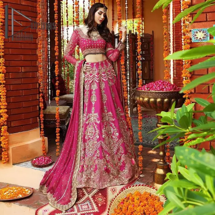 A color splash is always a floral dream. Let your energy shine with these popping Shocking Pink blouse that is ornamented with golden embroidery that involves tilla, dabka, Resham, and multi-color thread work just to magnify the display of the outfit. In addition to this, the full sleeves of the blouse when combined with a square neckline it gives a dazzling effect to the article. It is beautifully organized with can can lehenga that is also embellished with golden embroidery as well. Finalize this article with the same color dupatta that is adorned with four-sided lace and sequins spray all over just to fulfill your floral dream on your walima day.