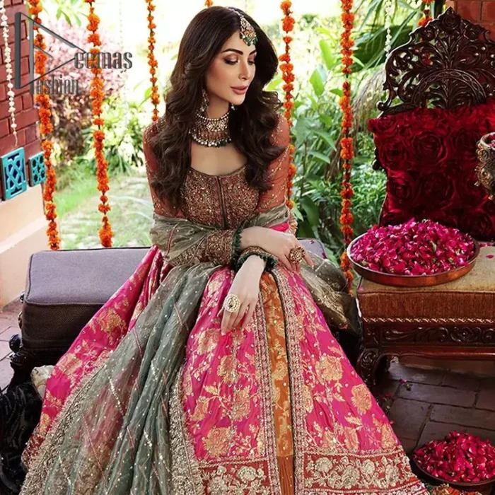 Be one with defying fashion winds and become a trendsetter. The captivating combination of front open style with the round neckline of shocking pink pishwas gives a stunning and smart look to you at any event. Pishwas is further furnished with attractive and handsome golden embroidery that includes mainly kora, dabka, and tilla work. Balance it with Rush Lehanga that have embellished with heavy border and sequins spray all-around to give soothing look. Complete this eventry look with a mint green dupatta that has been embellished with four-sided lace to give you a trendsetter look.